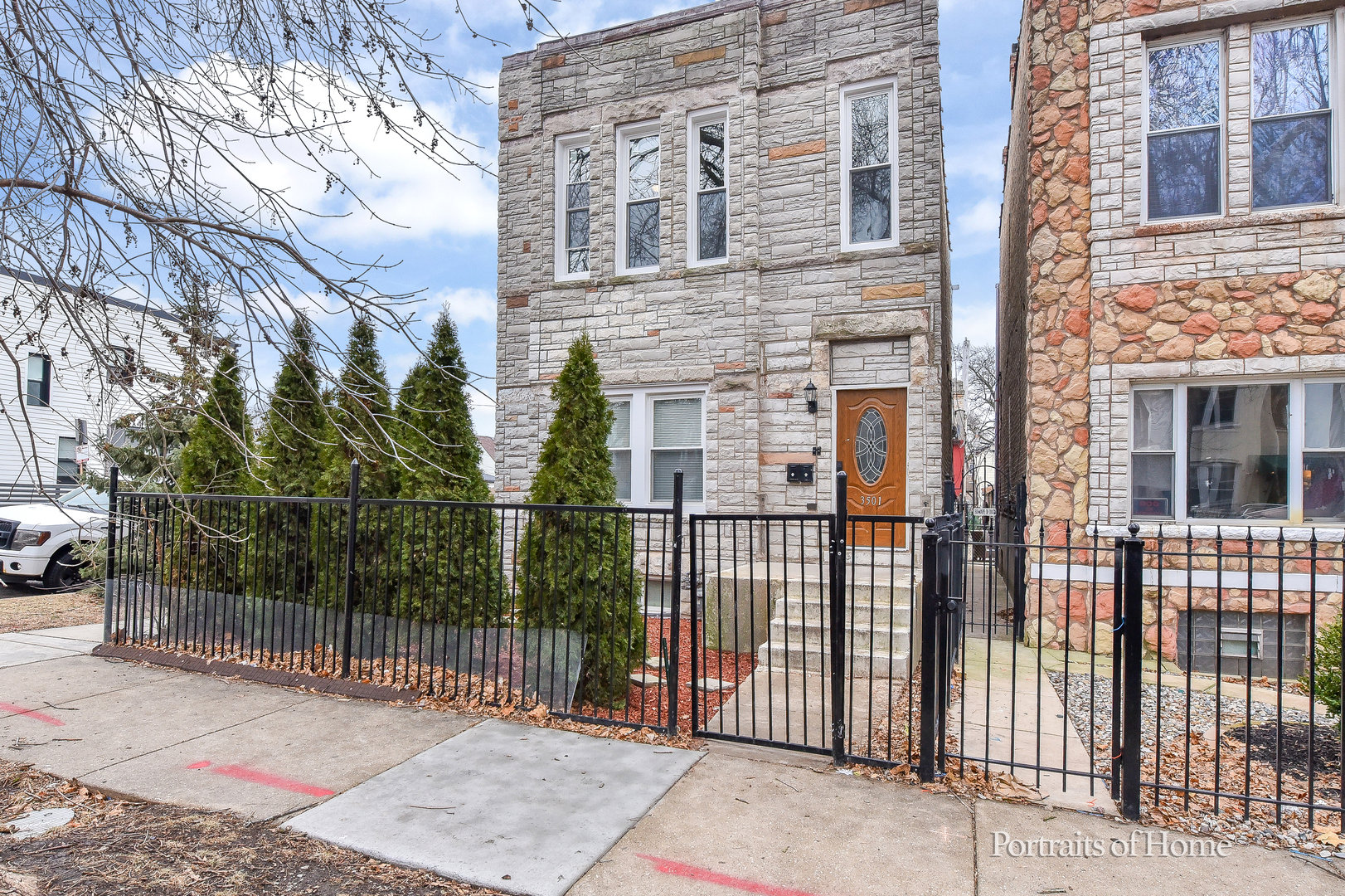 3501 West Le Moyne Street, Unit 1 Chicago, IL 60651 - Photo 1 of 27 a view of a brick house with a fence
