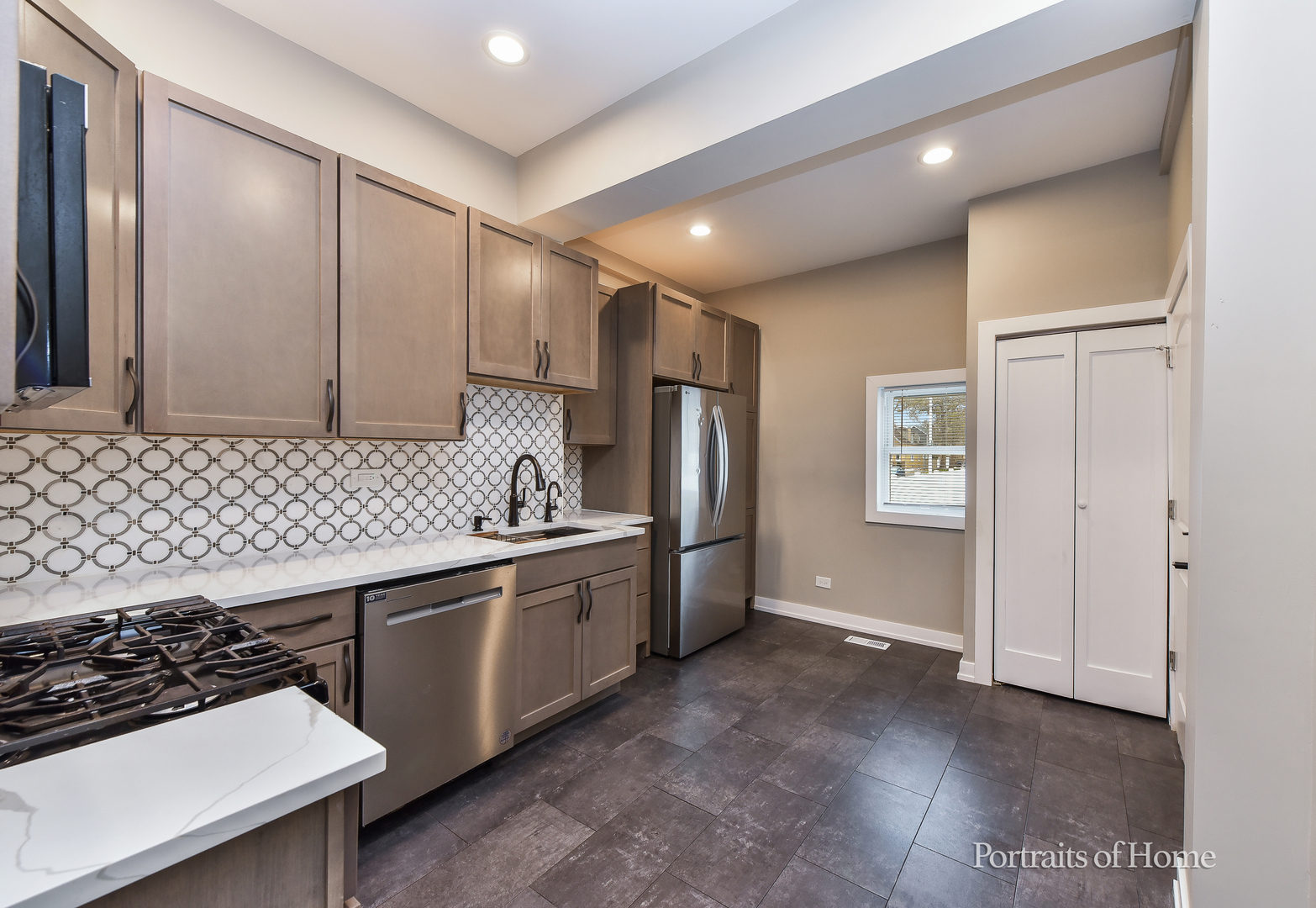 3501 West Le Moyne Street, Unit 1 Chicago, IL 60651 - Photo 7 of 27 a kitchen with stainless steel appliances a sink and a refrigerator
