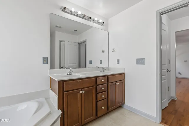 a view of bathroom with bathtub and window