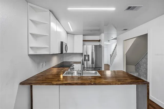 a view of staircase with wooden floor and white walls
