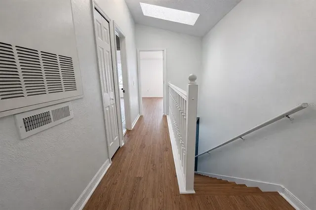 a bathroom with a granite countertop sink a toilet and mirror