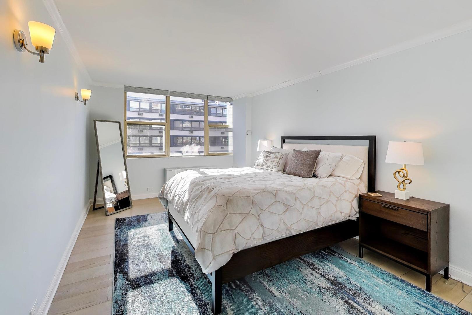 40 East Cedar Street, Unit 18B Chicago, IL 60611 - Photo 14 of 24 a bedroom with a bed and a window