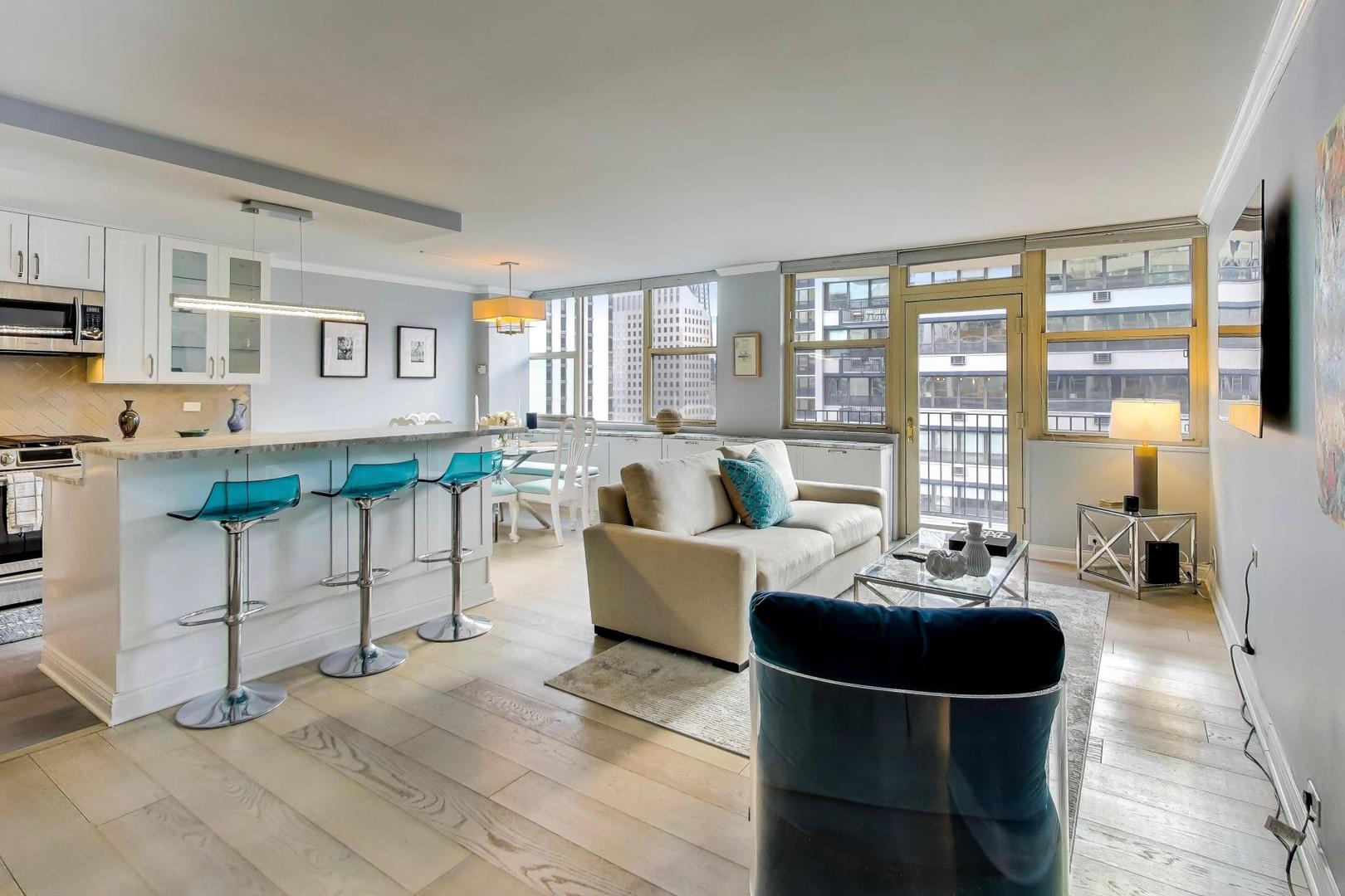 40 East Cedar Street, Unit 18B Chicago, IL 60611 - Photo 4 of 24 a living room with furniture and a large window