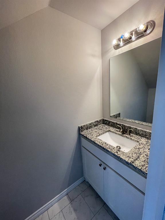 2740 Ginger Court Sherman, TX 75092 - Photo 12 of 16 a bathroom with a granite countertop sink and vanity