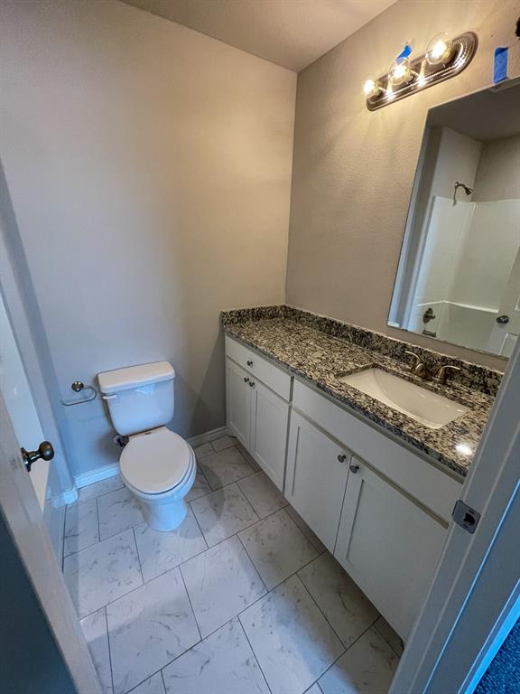 2740 Ginger Court Sherman, TX 75092 - Photo 4 of 16 a bathroom with a granite countertop sink and toilet