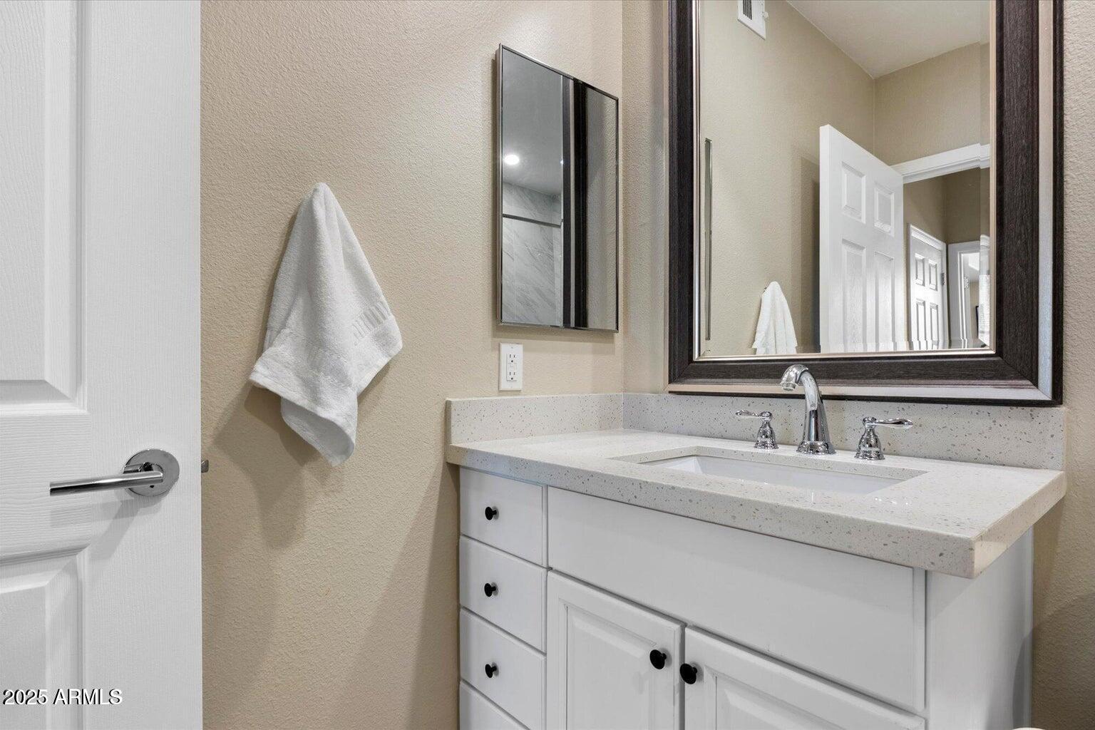 19777 North 76th Street, Unit 1229 Scottsdale, AZ 85255 - Photo 14 of 25 a bathroom with a sink and a mirror