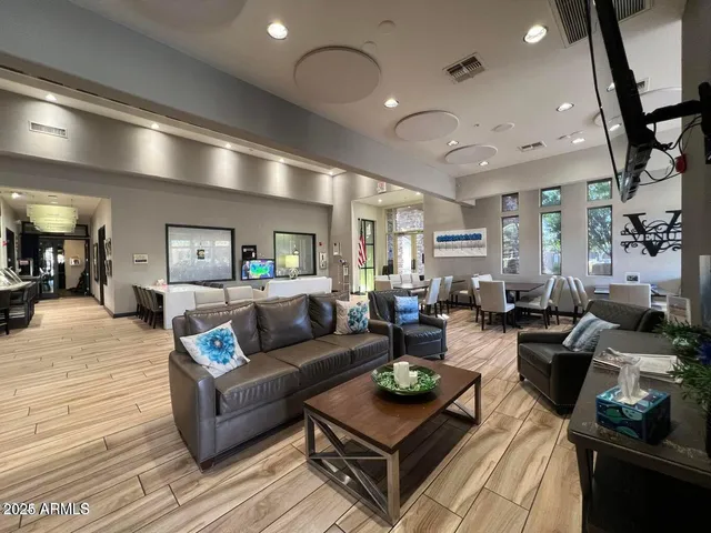 a living room with furniture and a wooden floor