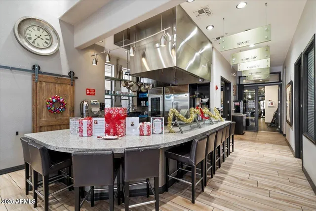 a dining area with stainless steel appliances kitchen island a table and chairs