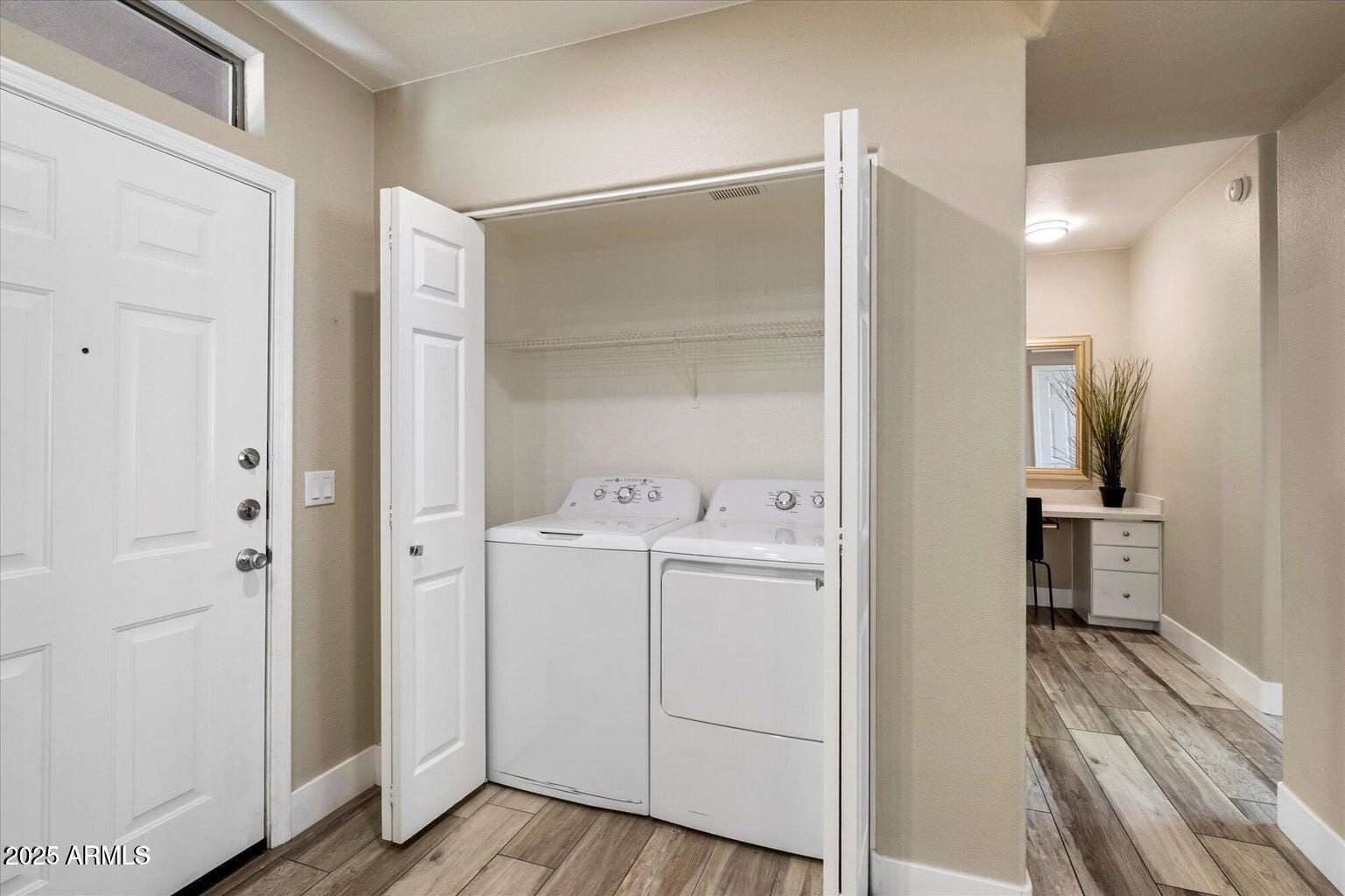 19777 North 76th Street, Unit 1229 Scottsdale, AZ 85255 - Photo 3 of 25 a view of utility room with closet and wooden floor