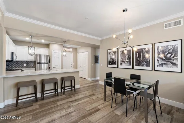 a large kitchen with a table and chairs