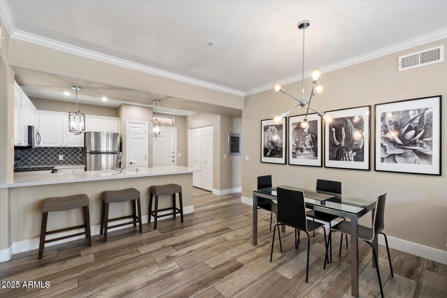 19777 North 76th Street, Unit 1229 Scottsdale, AZ 85255 - Photo 8 of 25 a large kitchen with a table and chairs