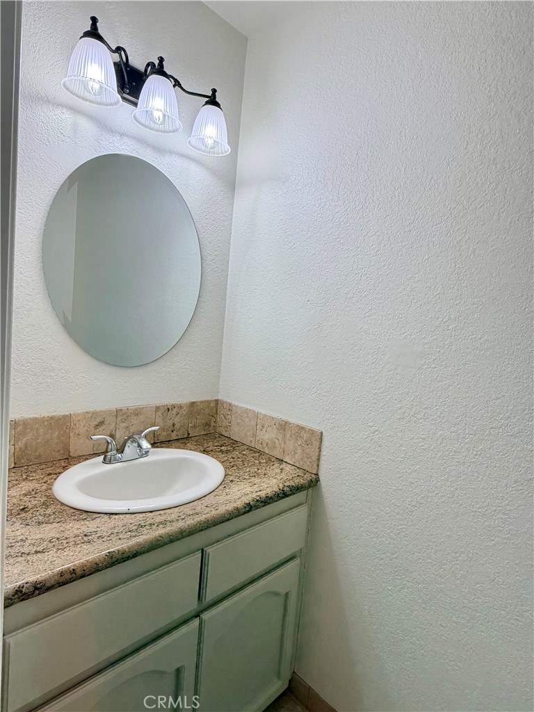 14840 Pamlico Road Apple Valley, CA 92307 - Photo 22 of 38 a bathroom with a sink and a mirror