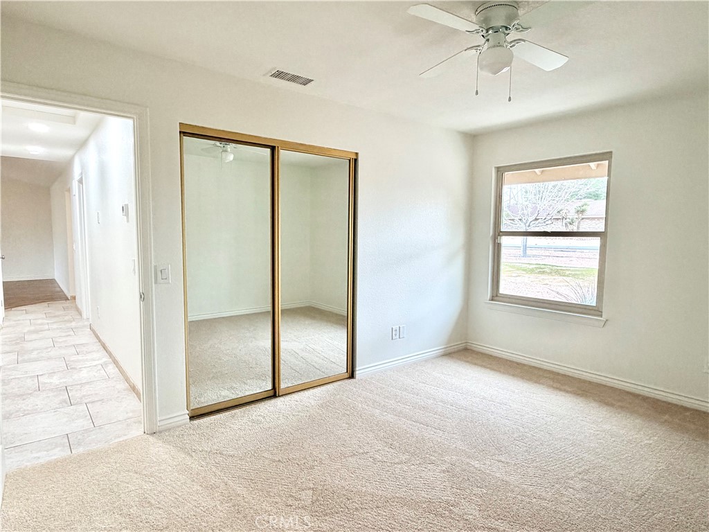 14840 Pamlico Road Apple Valley, CA 92307 - Photo 26 of 39 an empty room with fan and windows