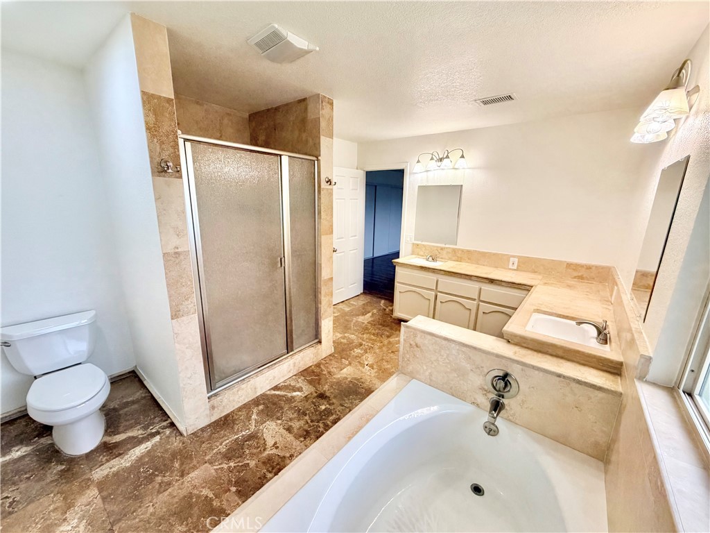 14840 Pamlico Road Apple Valley, CA 92307 - Photo 31 of 38 a bathroom with a sink and a large mirror