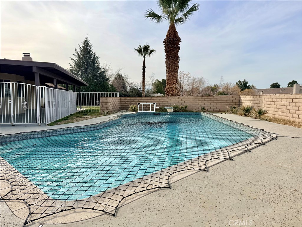 14840 Pamlico Road Apple Valley, CA 92307 - Photo 37 of 38 a view of a swimming pool with a chair and tables