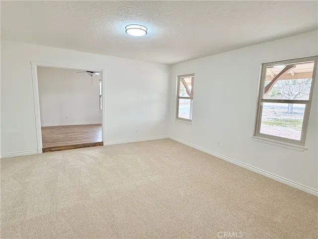 an empty room with windows and closet