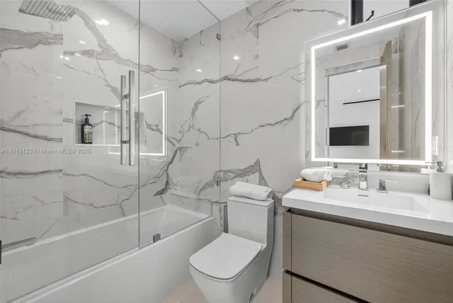 a bathroom with a shower and a glass door