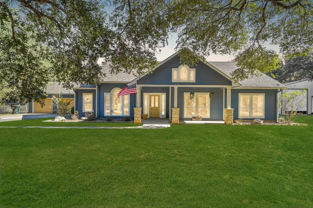 a front view of a house with a garden