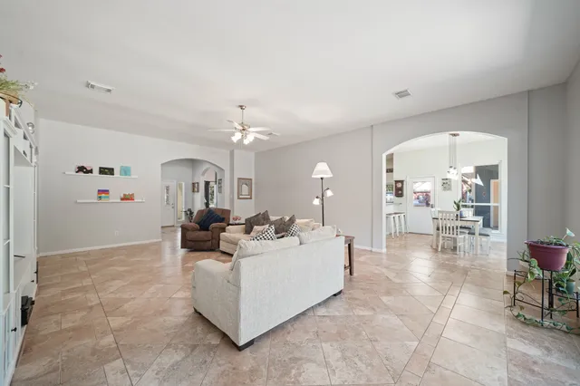 a living room with furniture and a chandelier