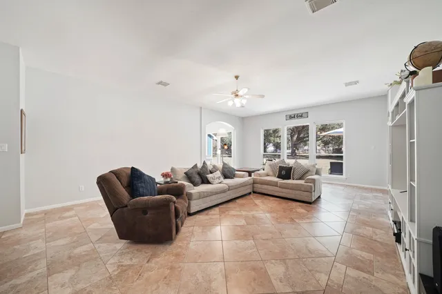 a living room with furniture and a chandelier