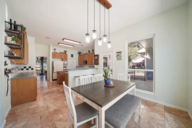 a view of a dining room with furniture and a chandelier