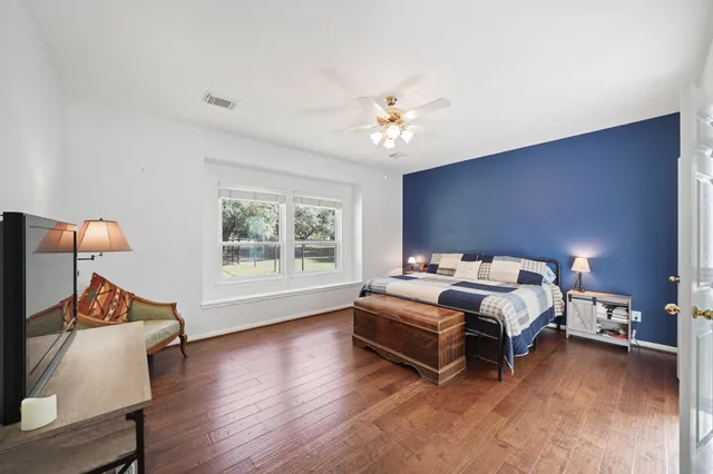 a spacious bedroom with a bed and a window