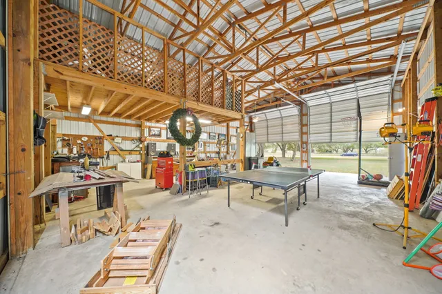 a roof deck with table and chairs and potted plants