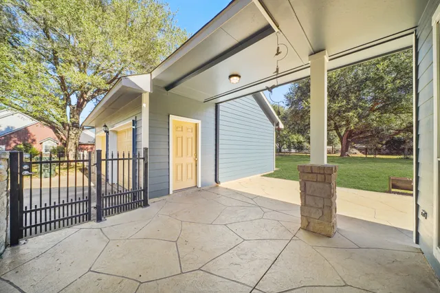 a front view of a house with a garden and trees