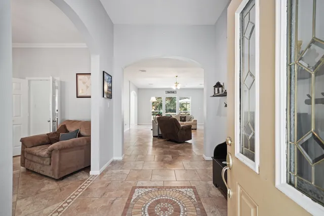 a living room with furniture and a floor to ceiling window
