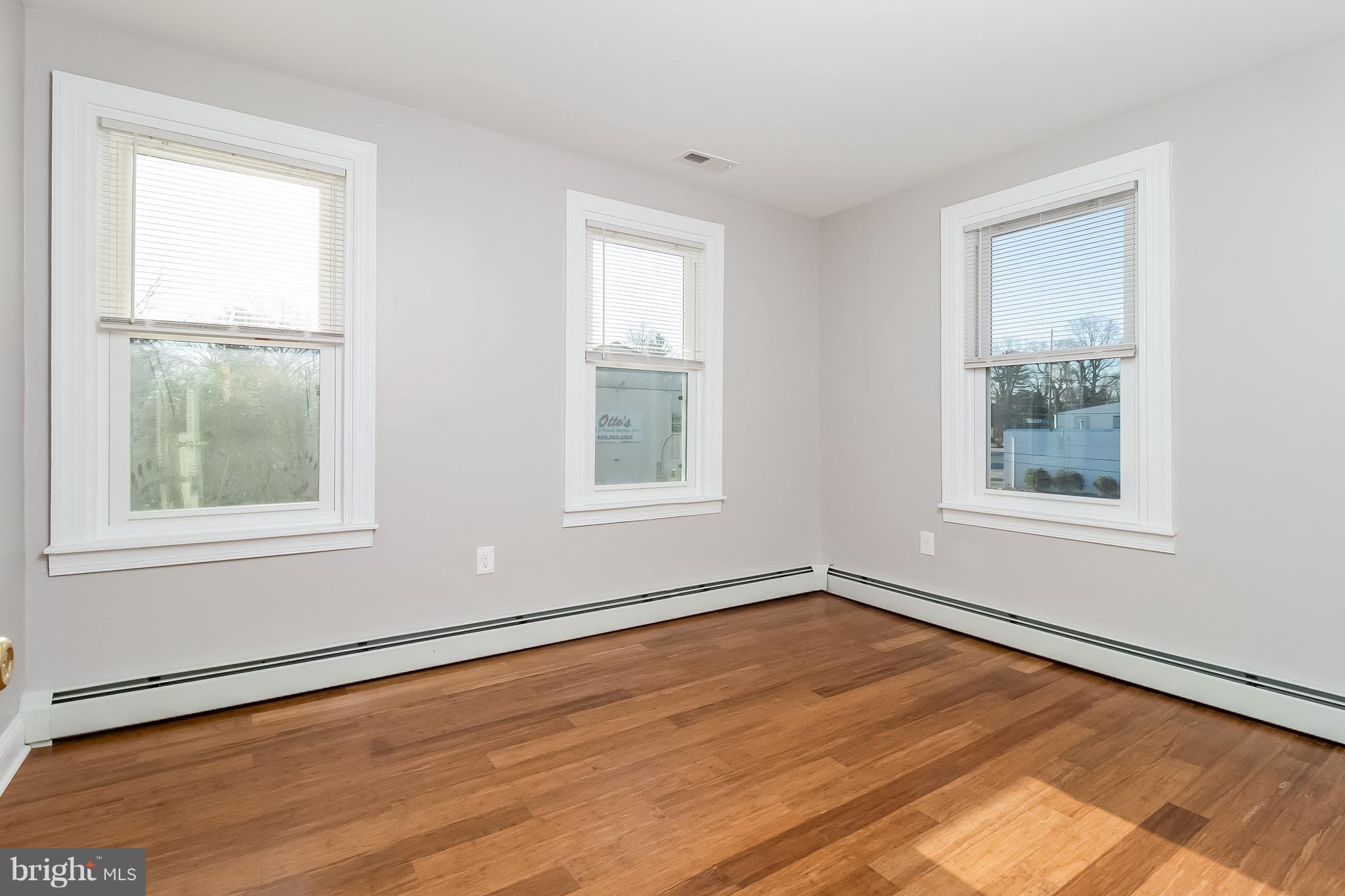 17 A State Road, Unit A Media, PA 19063 - Photo 14 of 19 a view of an empty room with wooden floor and a window