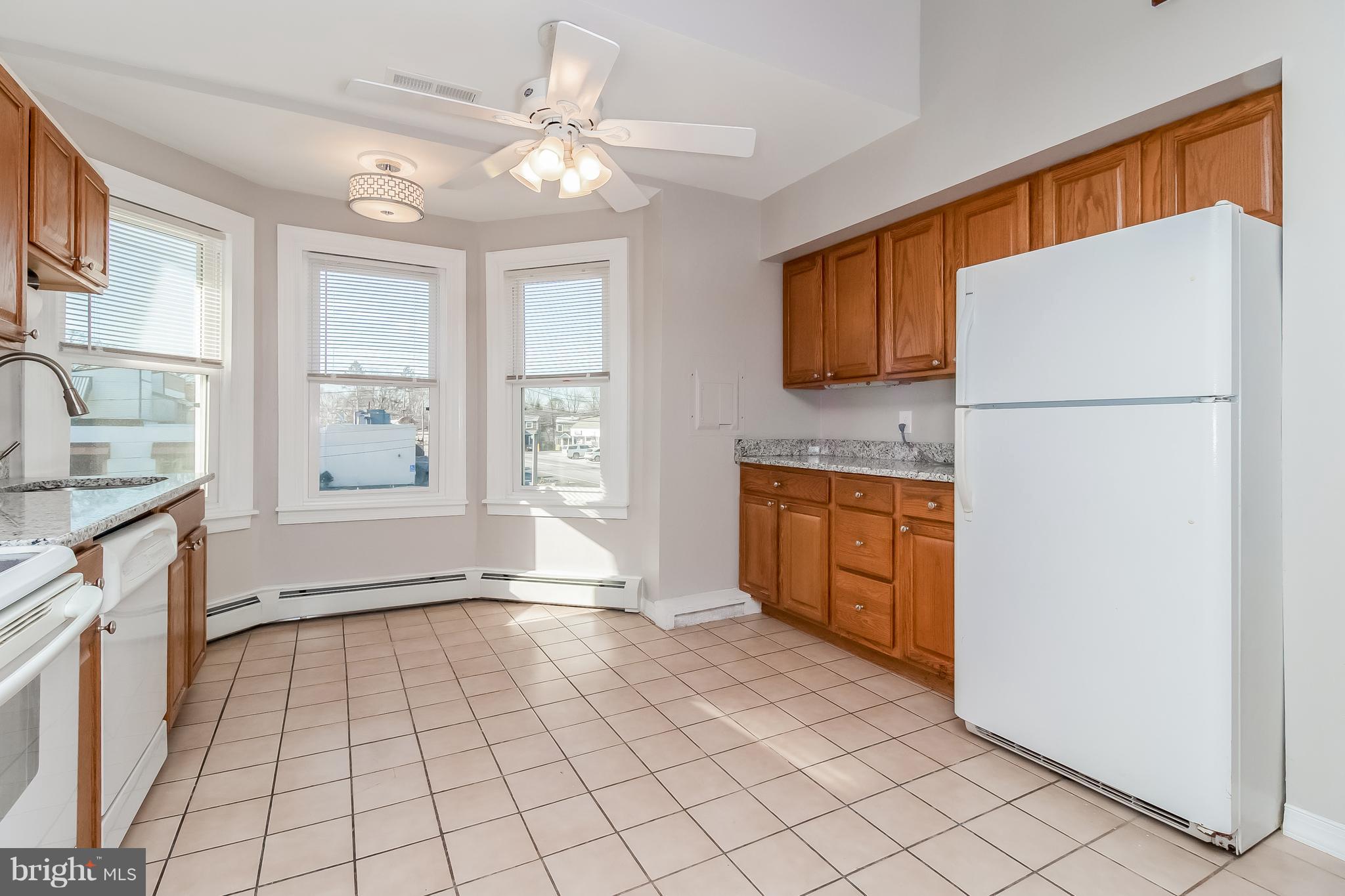 17 A State Road, Unit A Media, PA 19063 - Photo 2 of 19 a kitchen with a refrigerator a stove top oven and a window