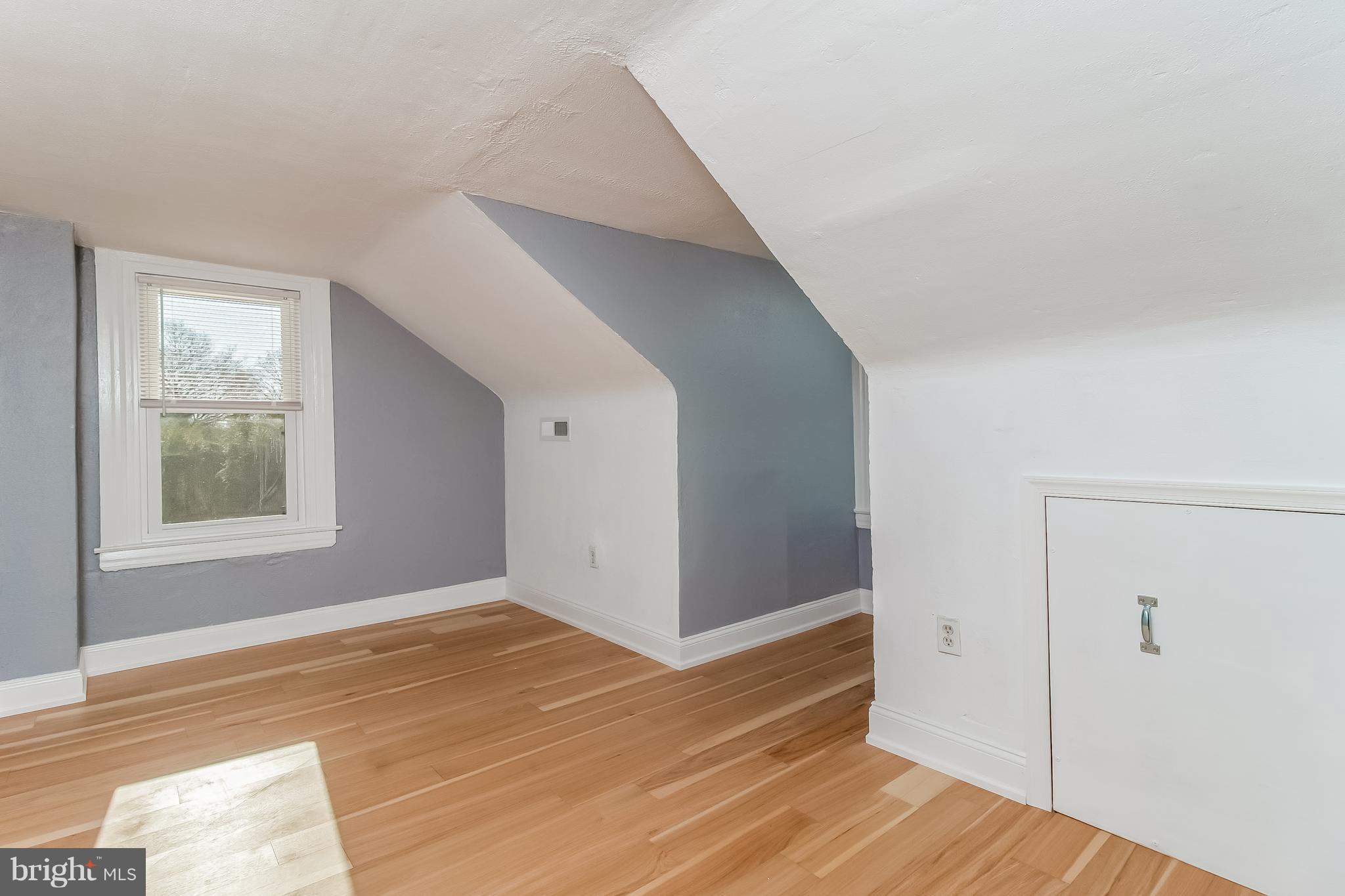 17 A State Road, Unit A Media, PA 19063 - Photo 8 of 19 a view of an empty room with wooden floor and a window