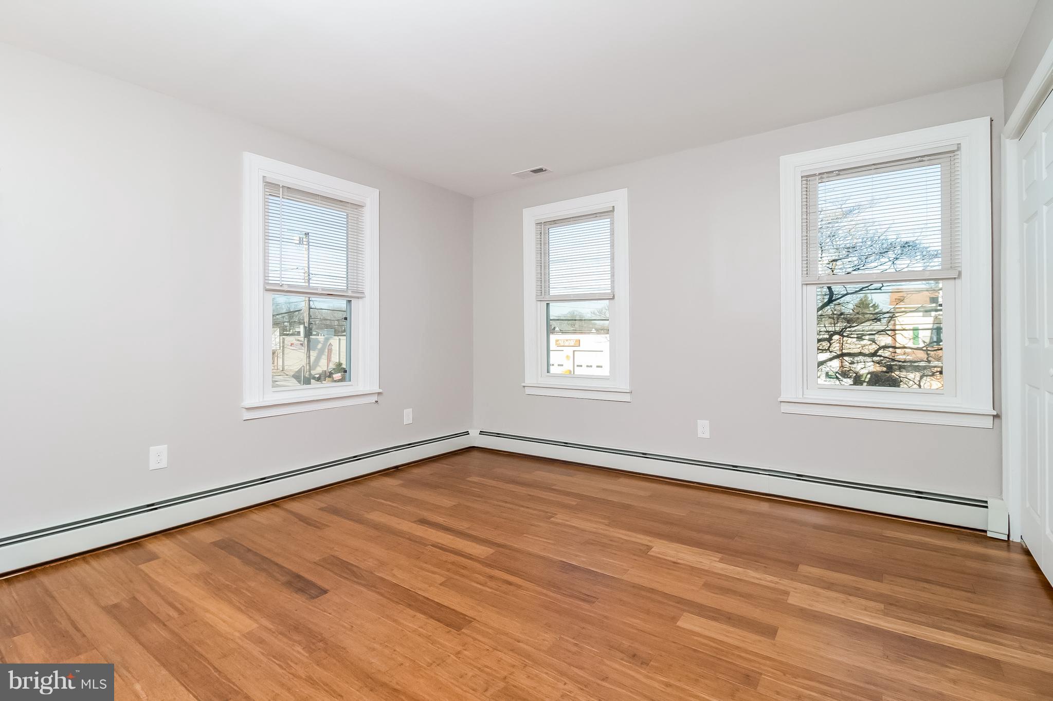 17 A State Road, Unit A Media, PA 19063 - Photo 10 of 19 a view of an empty room with wooden floor and a window