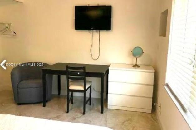 3221 Northeast 7th Street, Unit 1 Pompano Beach, FL 33062 - Photo 6 of 7 a living room with furniture and a flat screen tv