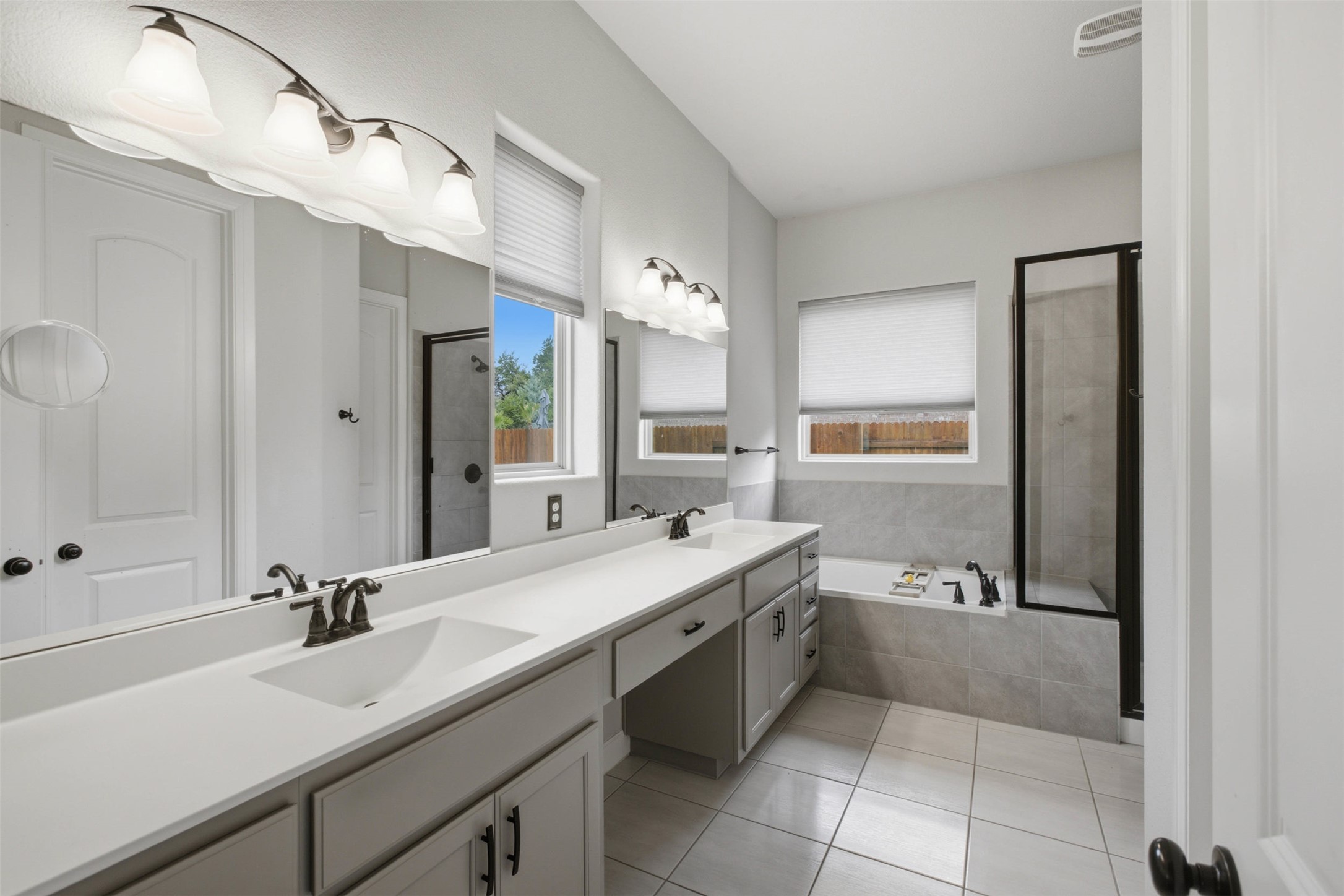 1113 Modoc Way Kyle, TX 78640 - Photo 19 of 34 Dual vanities and a deep soaking tub create a personal spa retreat.