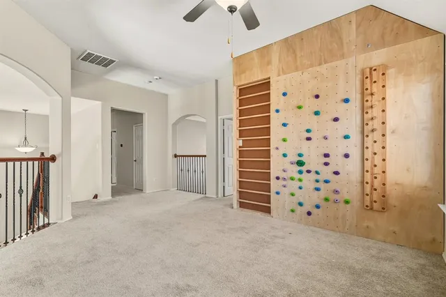 a view of a bedroom with closet and wooden shelves