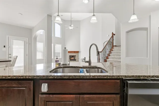 a kitchen with granite countertop a sink and a stove