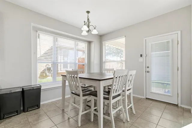 a view of a dining room with furniture windows and chandelier
