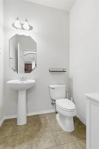 a bathroom with a sink toilet and a mirror