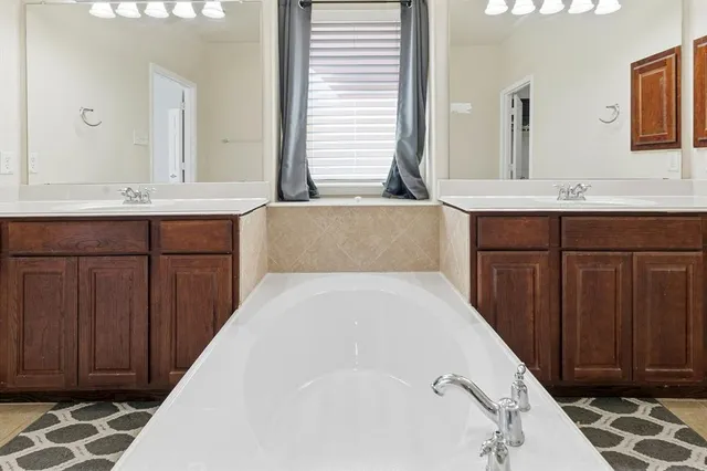 a bathroom with a double vanity sink and a mirror