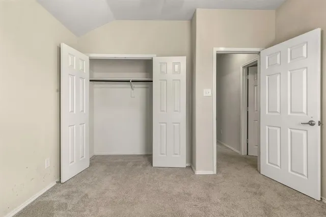 a view of an empty room with closet area