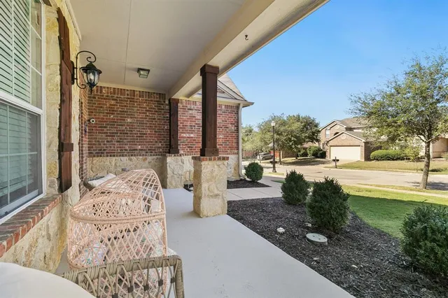 a view of a porch with furniture and garden