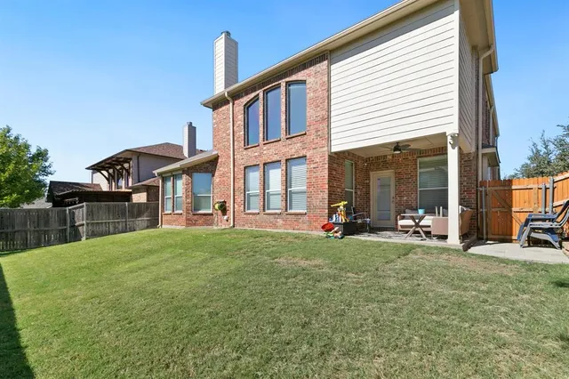 a view of a house with backyard porch and sitting area