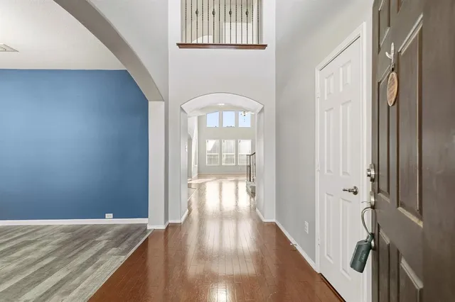 a view of an entryway with wooden floor