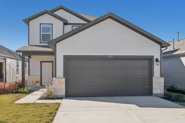 a front view of a house with garage