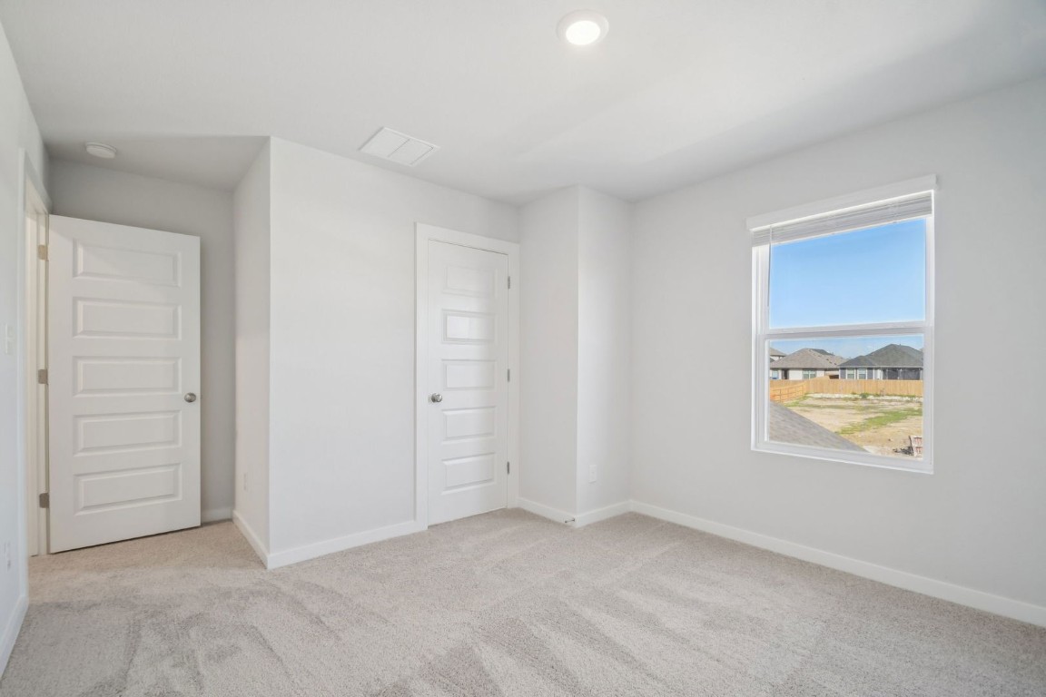 163 Two Bits Lane Elgin, TX 78621 - Photo 16 of 34 an empty room with windows