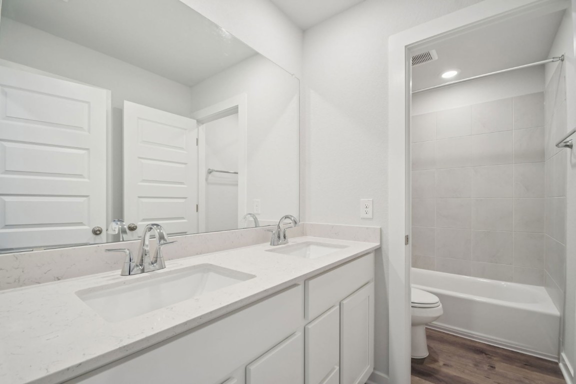 163 Two Bits Lane Elgin, TX 78621 - Photo 18 of 34 a bathroom with a sink and a bathtub