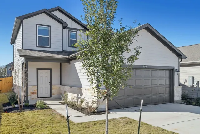 a front view of a house with garage