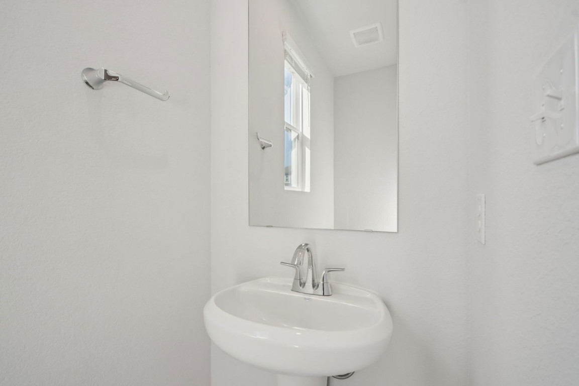 163 Two Bits Lane Elgin, TX 78621 - Photo 22 of 34 a bathroom with a sink and a mirror