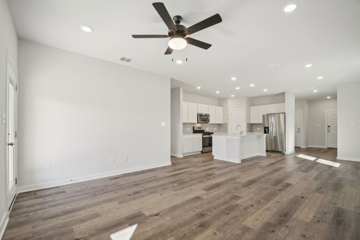 163 Two Bits Lane Elgin, TX 78621 - Photo 7 of 34 a view of kitchen with wooden floor and window